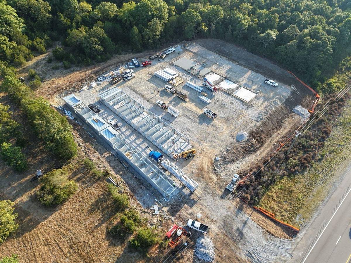 Aerial view: first two buildings framed in steel while slabs are poured for the rest